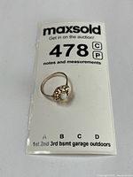 Ring on lot card showing overall size and design