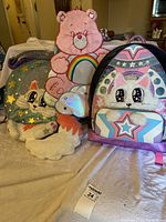 Front view of all three backpacks showing designs and relative sizes