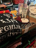 Overview showing altar cloth, rune stones, books, oracle decks, pendulum stand, red pouch