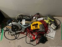 All items piled together showing tools, cords, power strip, manuals
