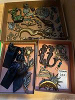 Overview of three trays showing varied metal décor pieces