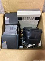 Box containing NES console, cartridges, controller, cables, pouch