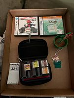 Overview showing boxed games, cartridge wallet, stylus holder, Maxsold tag