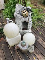 Group shot with faux stump fountain, frosted globes, glass jars, owl light