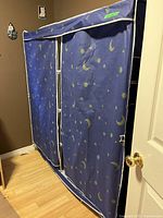 Front view of blue moon-and-stars fabric wardrobe closet