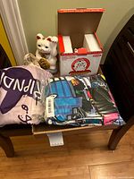 Sealed RIPNDIP hoodie, incense holder box, and ceramic Lucky Nermal figure on bench