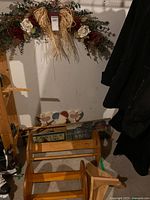 Full view of lot showing floral swag, magazine rack, plaques, shelves