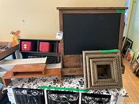 Group shot showing chalkboard, shelves, frames