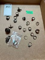 Full lot overview showing approx. 20 sterling rings in box
