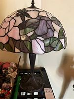 Full view of lamp showing stained glass shade and metal base