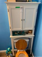 Full view of white over-the-toilet cabinet in bathroom setting