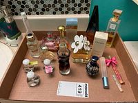 Overview of all perfume bottles and minis in cardboard tray