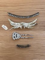 Four vintage hairpins and barrettes laid out on wood surface, showing entire lot
