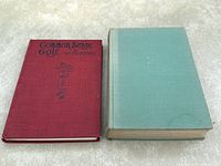 Both books stacked on a light surface showing red cover of Common Sense Golf and faded green cover of Golf by Henry Longhurst