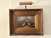 Frontal view of the painting, frame and overhead light