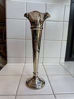 Front view of full vase showing trumpet shape, ruffled top and round foot