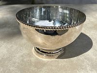 Side view of Sheffield silver plated rose bowl showing reflective surface and patterned rim.