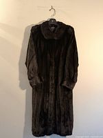 Full front view of coat hanging on wall