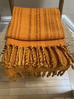 Folded blanket showing weave pattern and fringe