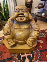 Full view of large wooden Buddha on octagonal base