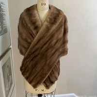 Front view of cinnamon brown mink wrap on dress form
