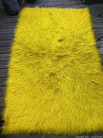 Full view of mustard wool flokati rug