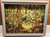 Full view of framed forest floor oil painting