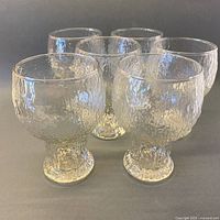 Six Indiana Glass Glacier goblets grouped, frontal view