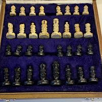 All 32 chess pieces stored in the lined interior of the wooden box