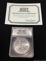 Certificate of Authenticity and obverse of the 2015 Silver Eagle coin in ANACS graded holder