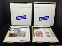 Two unopened mailers with JFK Half Dollar Centennial Collection coins, stamps, and ephemera inside.