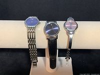 Front view of all three watches on display stand