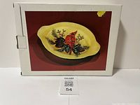 Photo of the original white box with an image of the cardinal serving plate on the lid showing the product and packaging condition.