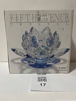 Front view of original box with image of light blue lotus shaped crystal candle holder from Fifth Avenue Crystal.