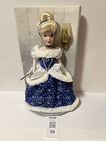 Front view of the Cinderella porcelain doll in her blue and white gown, showing detailed dress and hairstyle.