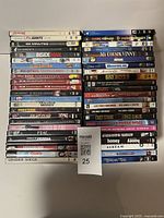 Photo showing 47 DVD movie cases stacked in two columns with visible titles