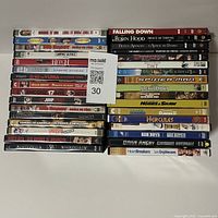 Photo showing a large stack of DVD cases with titles clearly visible for assortment verification.