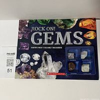 Front cover of Scholastic Rock On! GEMs book featuring colorful gemstones and a display window with four raw gemstones.