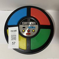 Top-down view of Milton Bradley Simon Game showing the four colored buttons and control panel.