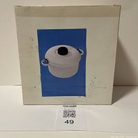 Box of the Regal microwave pressure cooker showing image of white pressure cooker with black knob on lid.