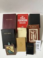 Nine religion books arranged in two rows on a white surface, photographed from above.