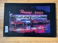 Front view of Rosie's Diner wooden sign with neon diner scene and vintage cars under night sky, showing reflections and vibrant colors.