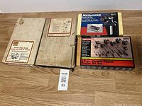 Overview of all four boxes including two vintage router edge guide boxes and two router bit sets by Mastercraft and Craftsman.