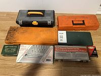 Overview photo showing all vintage tool cases and tool sets with seller label '85'. Includes plastic, metal cases and toolbox.