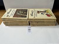 Two stacks of vintage Disney's Wonderful World of Knowledge hardcover books, showing front covers and spines with titles for identification.