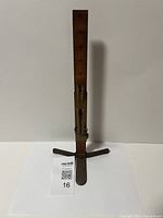 Full view of the vintage skirt trimmer standing against a white background showing 20 inch tall ruler and stable base.