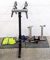 Complete lot showing Thule bike rack, Minoura bike trainer, cycling jacket, and Thule accessories on a foam mat floor.