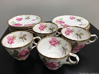 Photo showing 4 tea cups and 6 coffee cup saucers with Berkeley Rose floral pattern and gold trim.