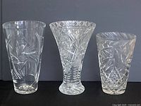 Three crystal vases together showing shape and cut designs