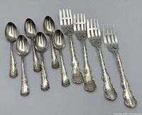 Eight-piece set laid out showing four forks and four spoons